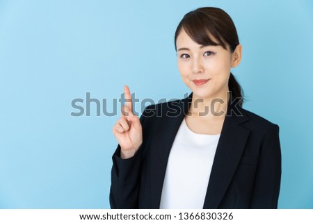 portrait of asian businesswoman isolated on blue background