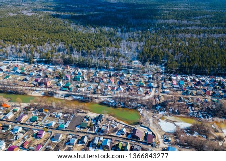 Aerial drone view of an old traditiona village in the forest, on background bly sky. 