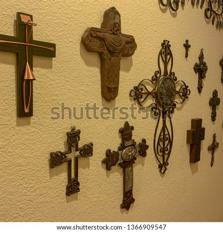 Multiple crosses displayed on wall.