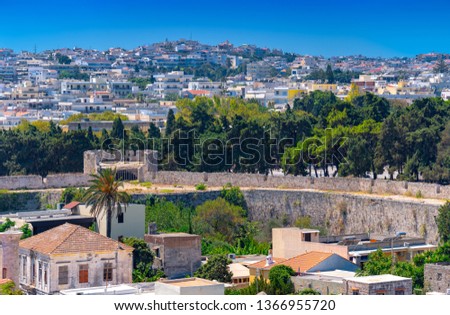 Panoramic view of the Rhodes medieval ancient stone defensive walls and the Spain Tower Pirgos Ispanias, with the new town in background. The island is a popular summer holiday destination in Greece