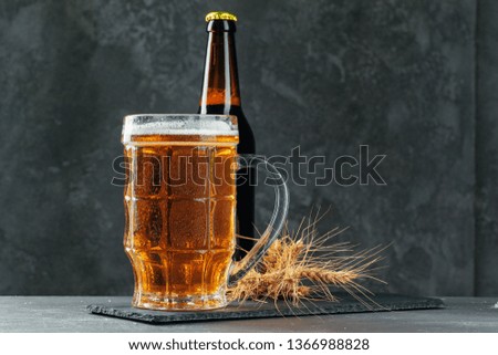 Single beer glass close up on dark stone background