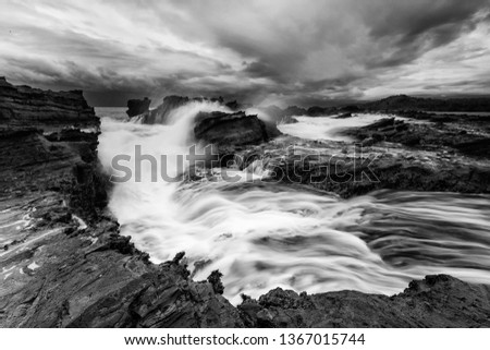 Black and White picture of Sawarna beach. Located in the province of Banten, Indonesia offers a host of natural wonders such asits rushing river, lush forest, rocky hills, caves, and more.