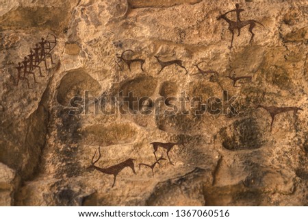 scenes of ancient hunting on the cave wall. history of antiquities, archaeology.
