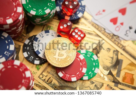 Colorful casino chips, dollars, bitcoins and red dice