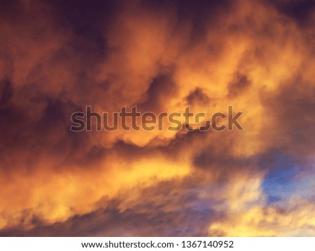 orange red clouds and deep blue sky sunset