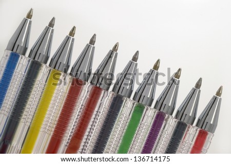 Coloured pens on white background.