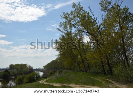 spring landscape by the river with blue sky and white clouds