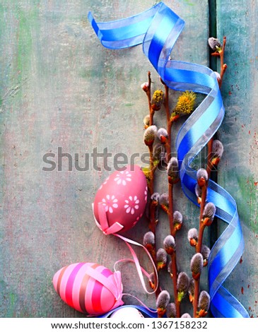 Easter eggs on table with beautiful flowers and blue ribbon stock photo