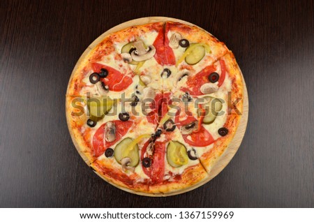 
Italian pizza with lots of vegetables and cheese. Meat and small layer of dough