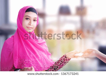Islam cute shopping lady with credit business,Muslim women wear hijab interested in intelligent media,shopping online,wifi,Arabian attractive woman holds paper colored bags.consumerism cyber concept 