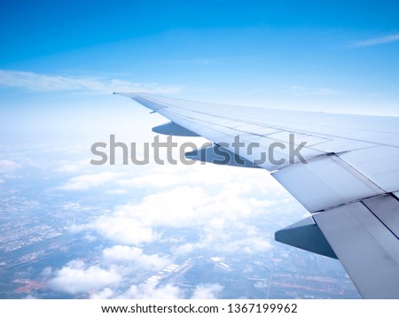 Skyline View above the Clouds and wing  from air plane ; Photo applied to tourism operators. picture for add text message or frame website. Traveling concept