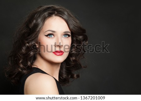 Beauty fashion portrait of pretty woman with makeup and healthy hair on blackbackground Royalty-Free Stock Photo #1367201009
