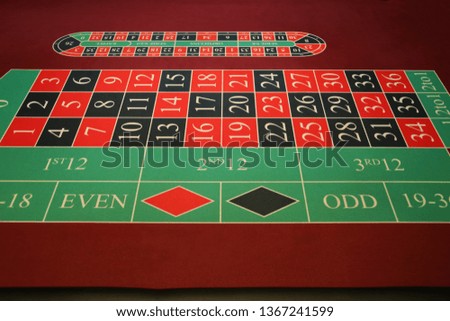 Close-up vibrant image of green casino table on black background