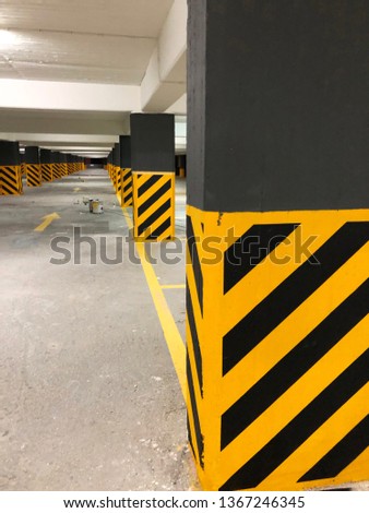Photo of a potential danger diagonal stripes on a columns in a car park.