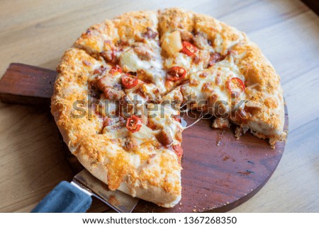 
Pizza placed on a wooden tray