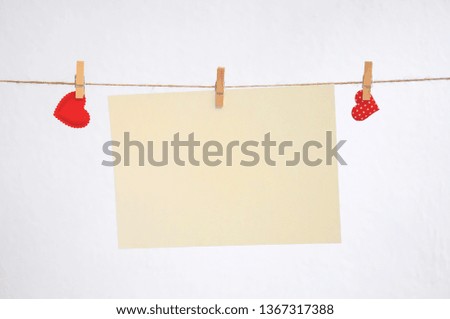 Hearts hang on clothespins on a white background.
Nick with hearts hanging on it and empty sheets.
Pattern for Valentine's day.