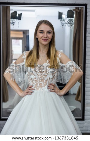 Beautiful blonde bride posing in wedding dress