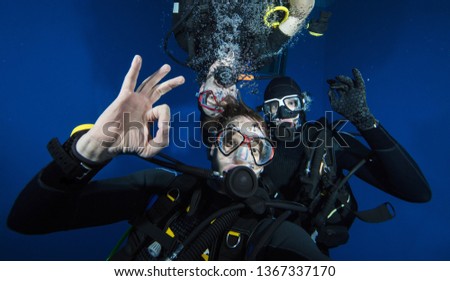 Young men scuba divers making selfie. Underwater sport and leasure activities.