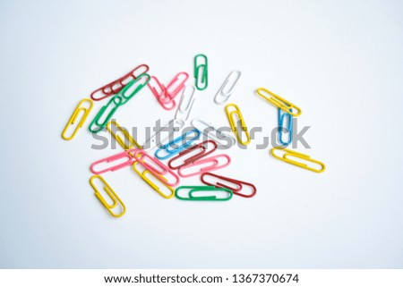 colored clips scattered randomly on white background