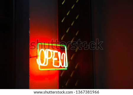 Blur image of "Open" sign of bar and restaurant. Custom neon light text. Concept image for nightlife and entertainment.