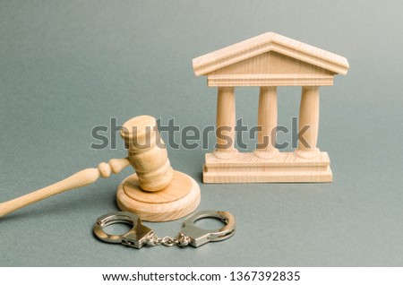 Courthouse and handcuffs. The concept of the court. Verdicts in criminal cases. Justice. The judicial system. Legal power. Criminal Code. Repression and persecution of activists and oppositions.