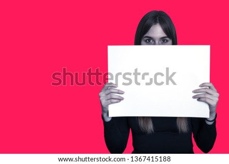 The girl with a white sheet on a red background with a blank sheet