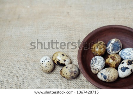 a basket of quail eggs on burlap. village theme