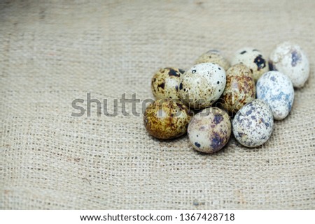 a basket of quail eggs on burlap. village theme