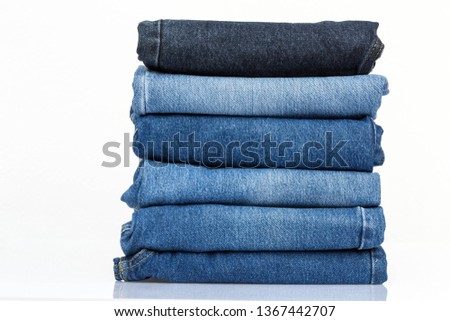 Jeans trousers stack on white background Royalty-Free Stock Photo #1367442707