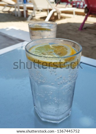 Glass of mineral waters with beach background