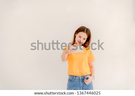 Asian women holding phones while selfies Asian women with smiling faces, smiling selfies on a white background Women taking selfies