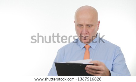 Confident Businessman Image Reading and Taking Notes Using Agenda