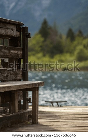Wooden pier at mountain lake with forest in the background