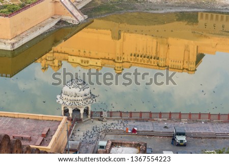 Reflection of Amber fort and palace in Maotha Lake at morning. Jaipur. Rajasthan. India