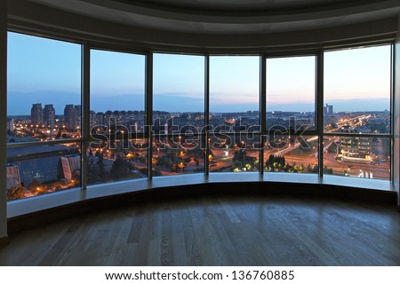 Big glass wall in oval living room with cityscape view Royalty-Free Stock Photo #136760885