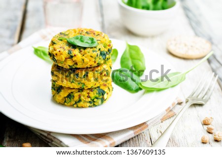 Quinoa spinach chickpeas pumpkin fritters on a wood background. toning. selective Focus