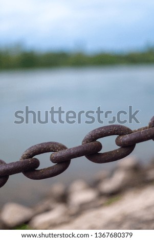 CloseUp of a Chain in front of a river. 