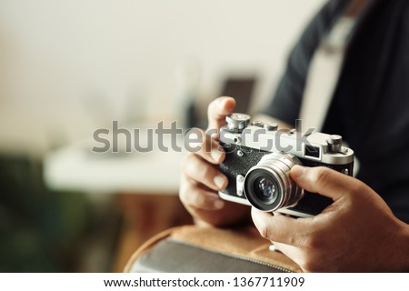 Photographer hands holding vintage camera 
