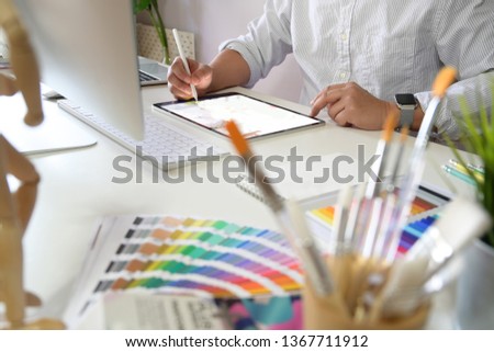 Young Artist and graphic designer at studio workspace 