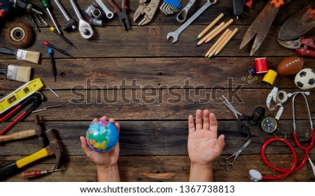 international workers day and labour day 2019, Globe in the hands Working tools on wooden rustic background with copy space. Top view, 