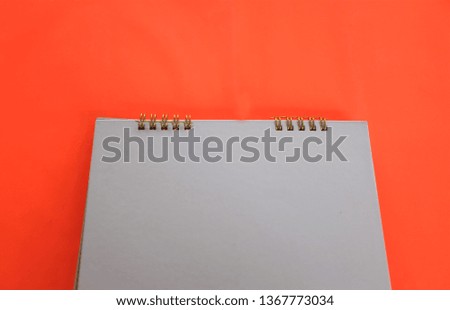 top view and close up notebook on orange background.