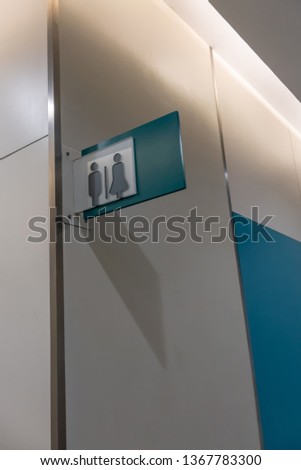 Modern restroom sign or toilet sign with man and woman icon set symbol on white concrete wall background, modern, hygiene and clean restroom concept