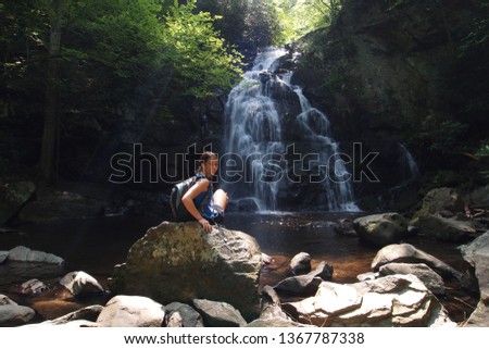 Young woman enjoying Spruce Flats Falls in the Great Smoky Mountains National Park, Tennessee, in early summer.