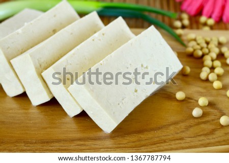 Sliced tofu on wood cutting board Royalty-Free Stock Photo #1367787794