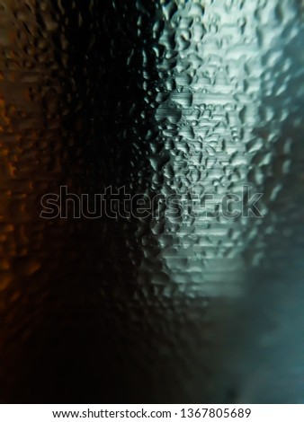 A glass of water. Macro shot of glass water. The water bubbles on the steel glass.