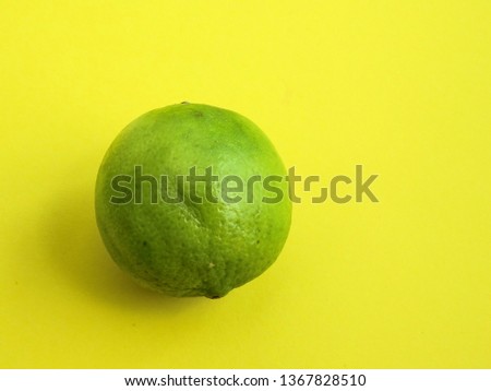 Close-up of a Isolated lime on a bright yellow background