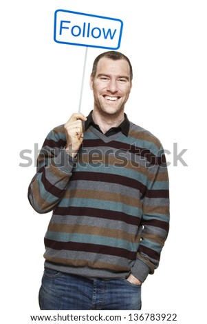 Young man holding a social media sign smiling on white background