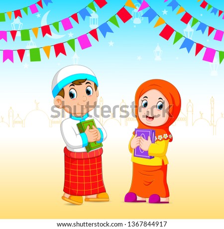 the boy and the girl is holding the al quran in the Ramadan event