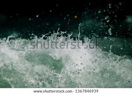 Splashes of water from the waves in the sea .