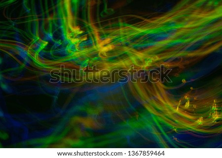Bokeh abstract background with colorful lights in motion. Blur lens flare glow.